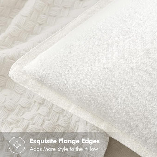 Close-up of the woven linen texture and subtle slub pattern on a cream white pillow cover.