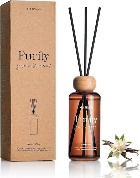 Elegant reed diffuser set featuring a clear glass bottle filled with jasmine sandalwood essential oil.