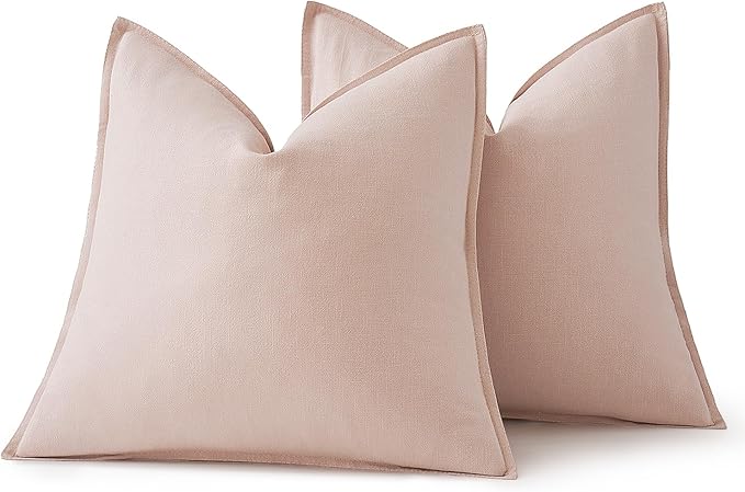 Light pink pillow cover styled on a bed, contributing a charming and cozy accent.