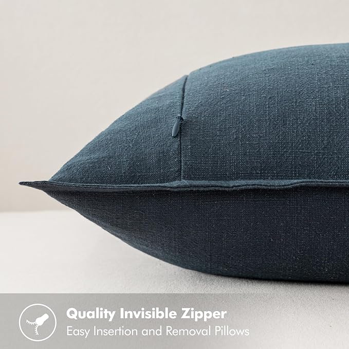 Two navy blue linen pillow covers neatly stacked, showcasing their elegant hue and quality craftsmanship.