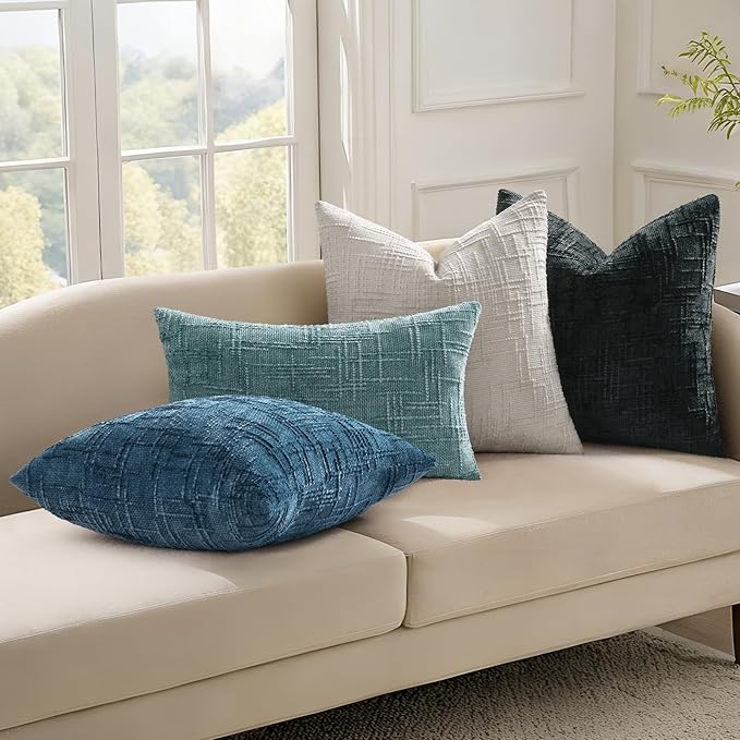 View of the reverse side of the black chenille pillow cover, emphasizing the fabric's thickness.