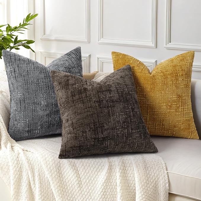 Stack of two dark brown chenille pillow covers, emphasizing their soft, substantial feel and thickness.
