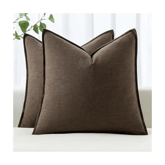 Two dark coffee linen throw pillow covers on a light sofa, adding a warm, inviting modern accent.