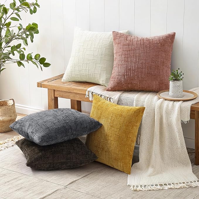 Pink chenille throw pillow covers used as accent decor on a modern neutral sofa in a living room.
