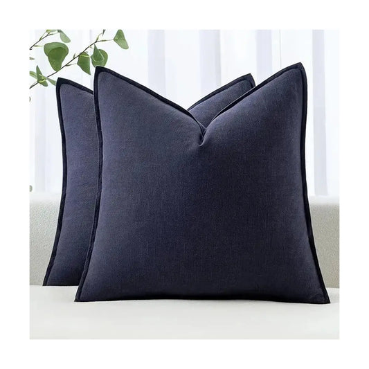 Two navy pillow covers arranged on a light-colored sofa, enhancing a modern farmhouse theme.
