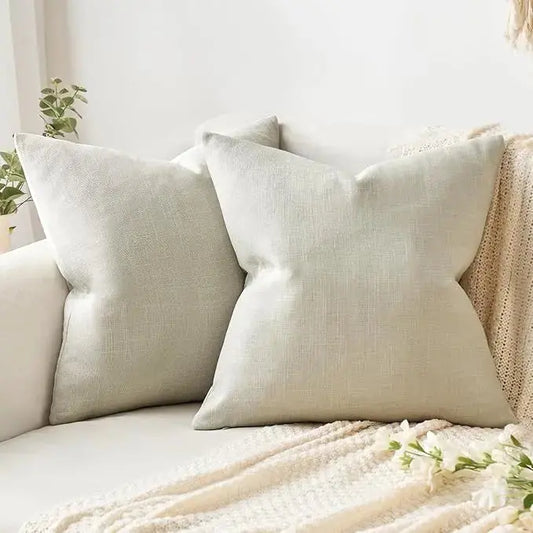 Pair of greyish white linen burlap throw pillow covers, square 16x16 inch, displayed flat.