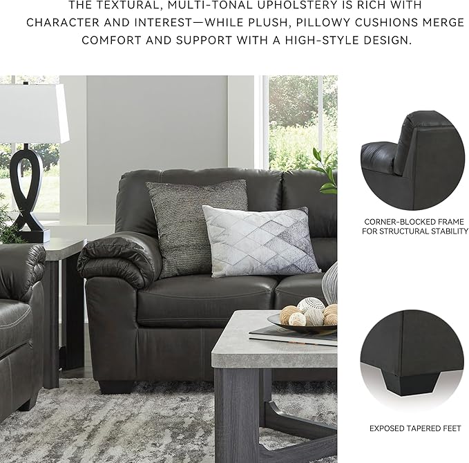 A wider shot of the gray sofa within a contemporary living room setting, with decor.