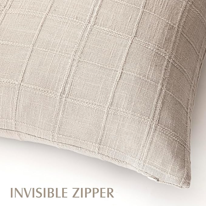 Natural linen check lumbar pillow covers accenting a bed with neutral bedding in a farmhouse bedroom.