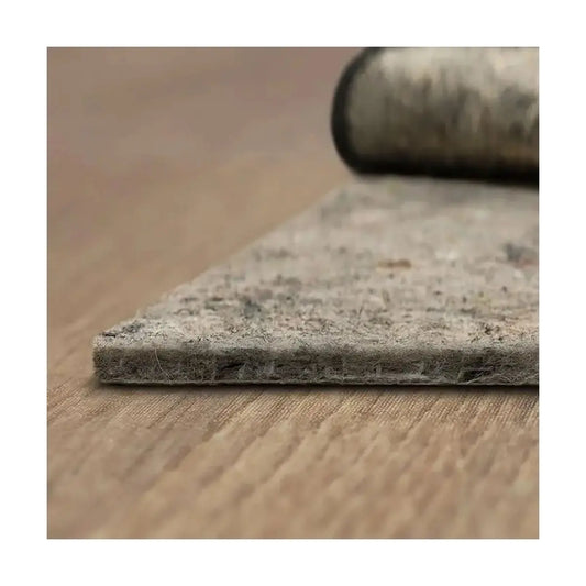 Rectangular rug pad, 6' x 9', laid flat on a light-colored floor, showing its textured surface.
