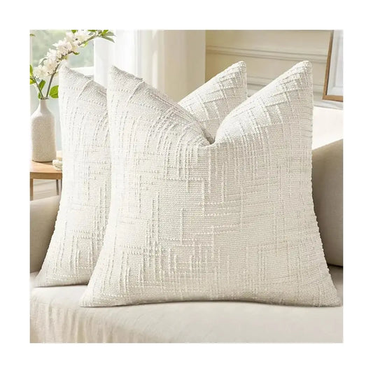 Cream white chenille throw pillow covers (set of 2) on a sofa, showcasing thick textured fabric.