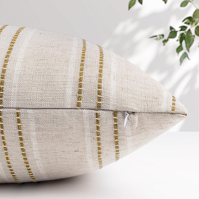 A pair of beige and white brown striped pillow covers neatly folded, highlighting the linen fabric texture.