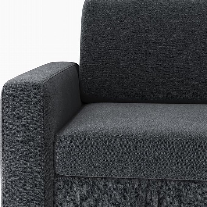 The dark gray sectional sofa arranged to show the reversible chaise on the opposite side of the couch.