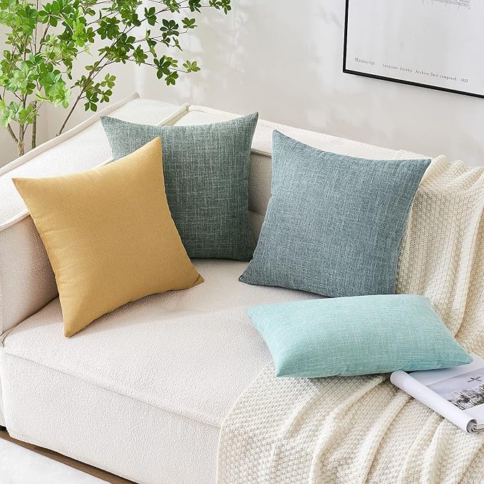 Detailed shot of the sturdy stitching and corner of a sage green pillow cover.