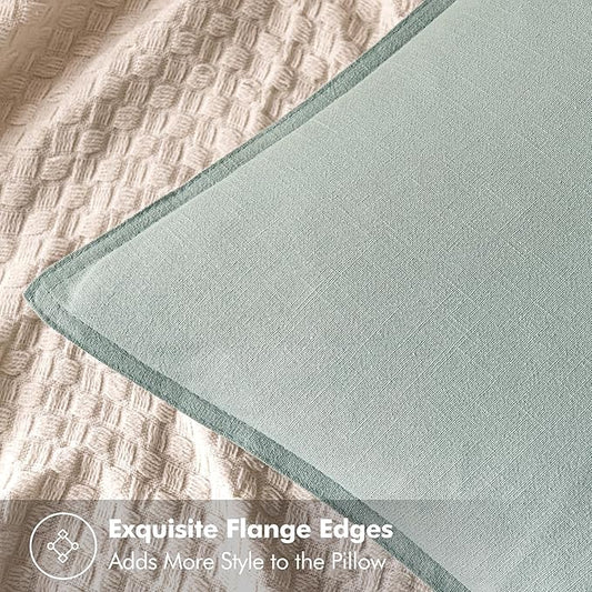 Close-up of the textured aqua green linen fabric, showing its weave and neutral tone.