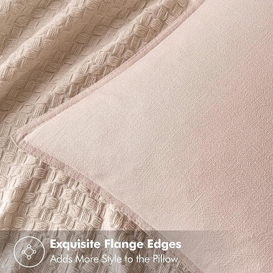 Close-up of the light pink linen fabric, revealing its delicate texture and subtle color.