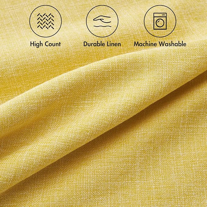 A single yellow decorative pillow cover arranged on a bed with other decorative pillows.