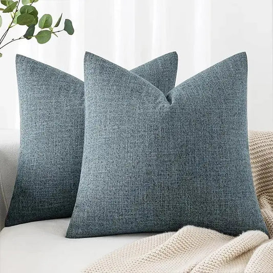 Pair of dusty blue linen burlap throw pillow covers displayed flat, showing textured fabric.