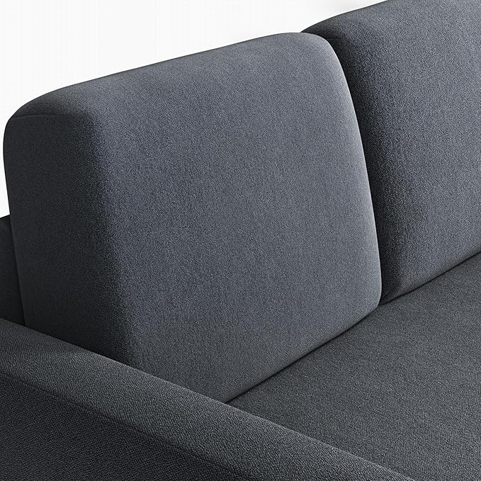 Close-up of the fabric texture on the dark gray sectional sofa cushions and armrests.